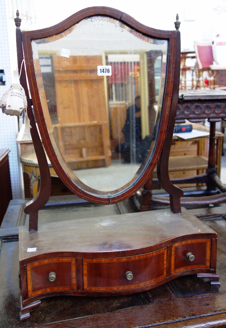 Appraisal: A George III satinwood banded mahogany shield shaped toilet mirror