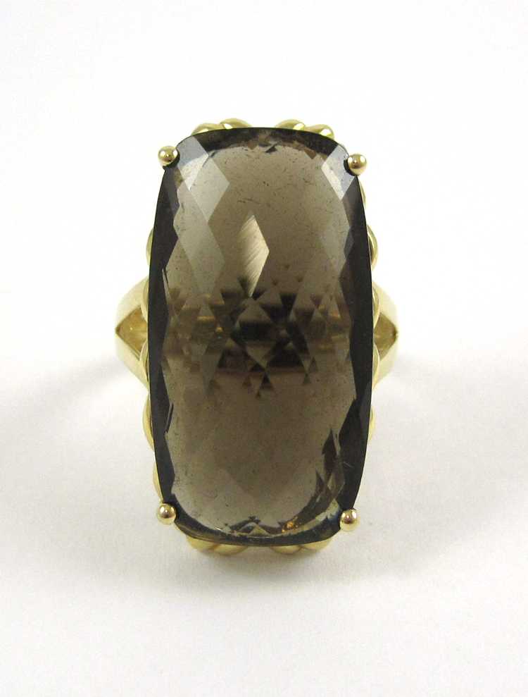 Appraisal: SMOKY QUARTZ AND FOURTEEN KARAT GOLD RING set with a