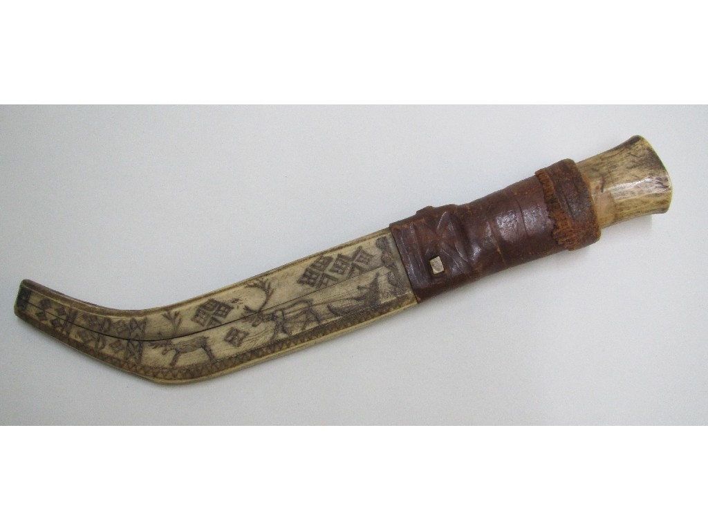 Appraisal: A Lapp knife the reindeer bone sheath engraved with a