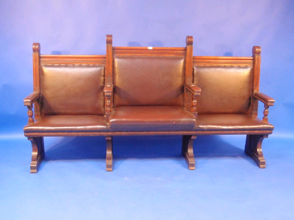 Appraisal: An Edwardian oak Magistrates bench with brown rexine studded upholstery