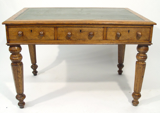 Appraisal: Victorian oak desk with green tooled leather insert above a