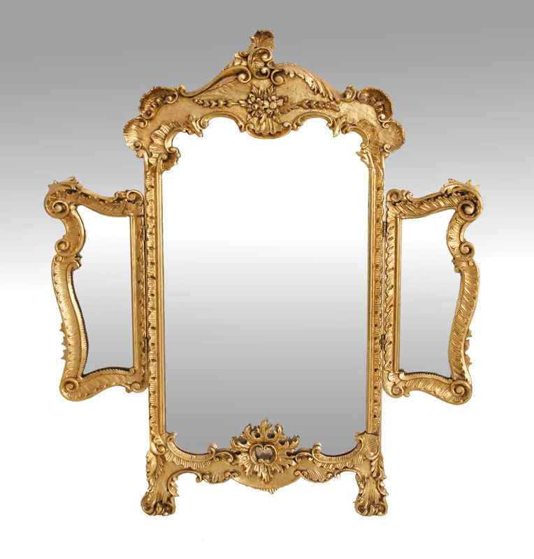 Appraisal: ORNATE CARVED GILT WOOD PETTICOAT MIRROR Easel back triple mirror