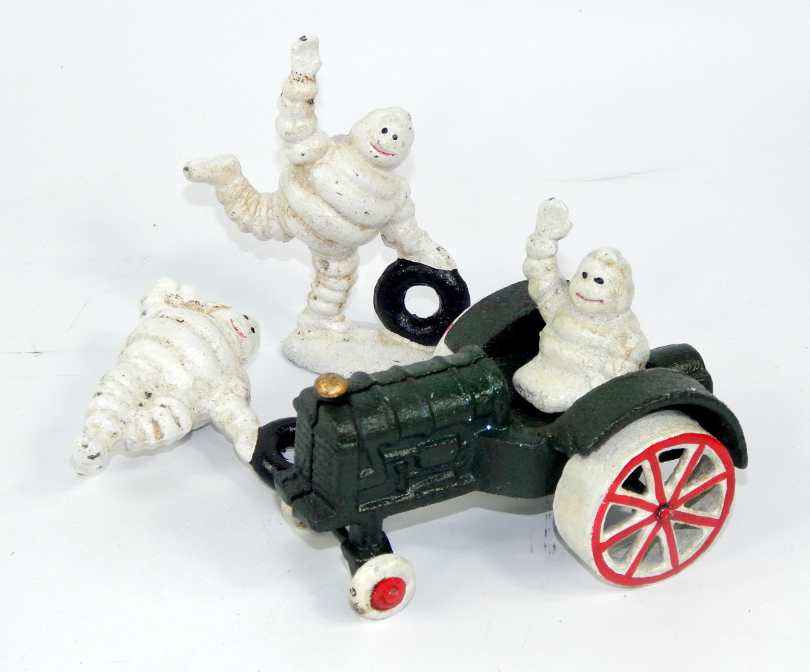 Appraisal: Two enamel Michelin Man figures and a Michelin Man on