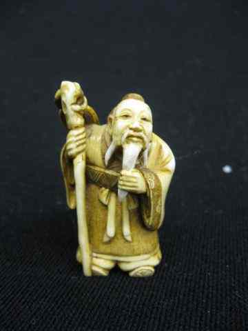 Appraisal: Carved Ivory Netsuke of an Old Manwith staff ''