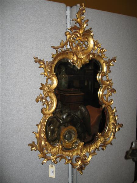 Appraisal: A th century carved giltwood wall mirror the cartouche shaped