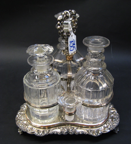 Appraisal: AN ENGLISH SILVER PLATED THREE-BOTTLE TANTALUS containing a pair of