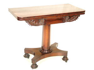 Appraisal: A Victorian rosewood foldover tea table circa the rounded top