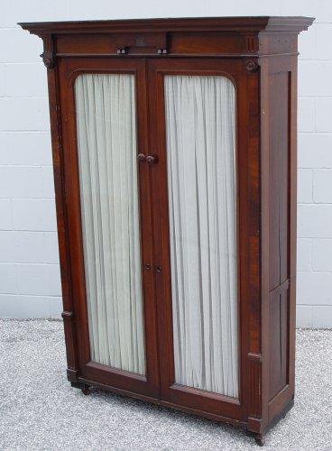 Appraisal: VICTORIAN WALNUT GLASS DOOR BOOKCASE Crown molded top beveled panel