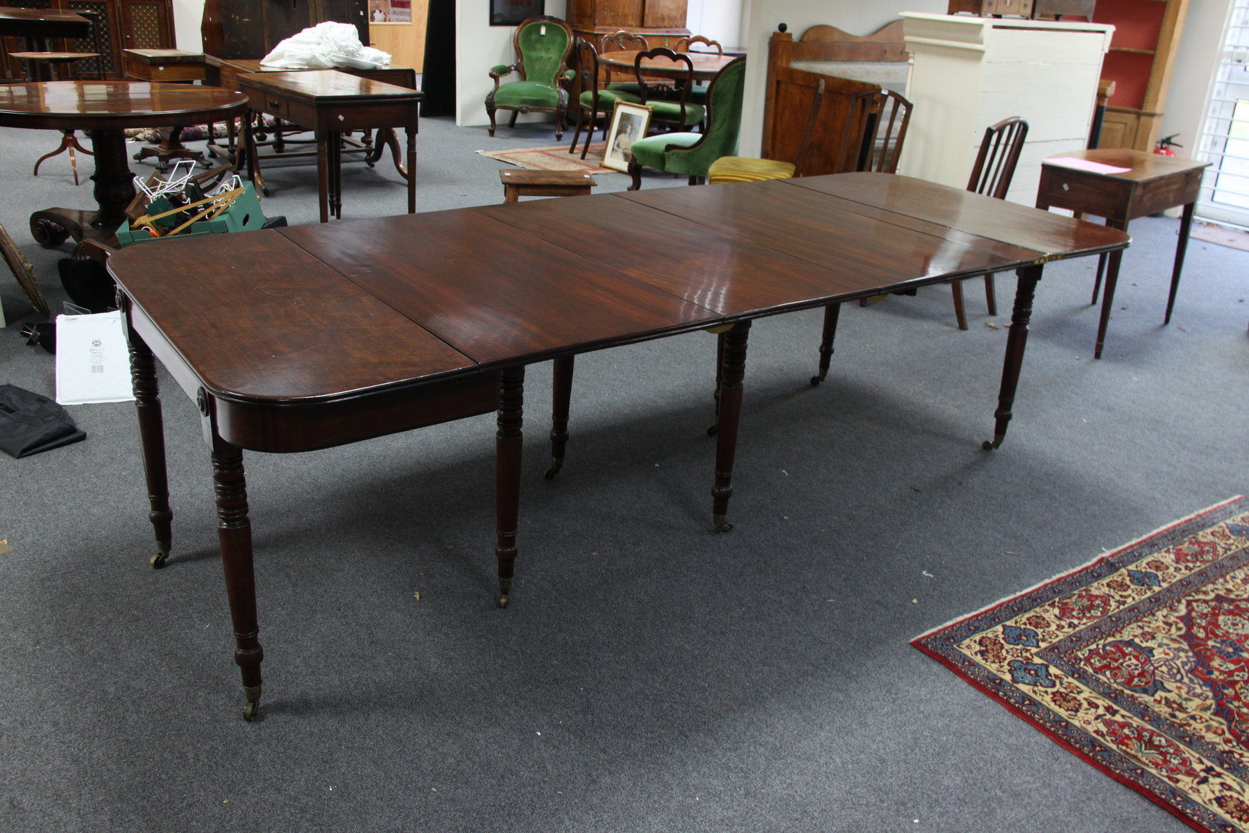 Appraisal: A George IV mahogany extending dining table fitted three extra