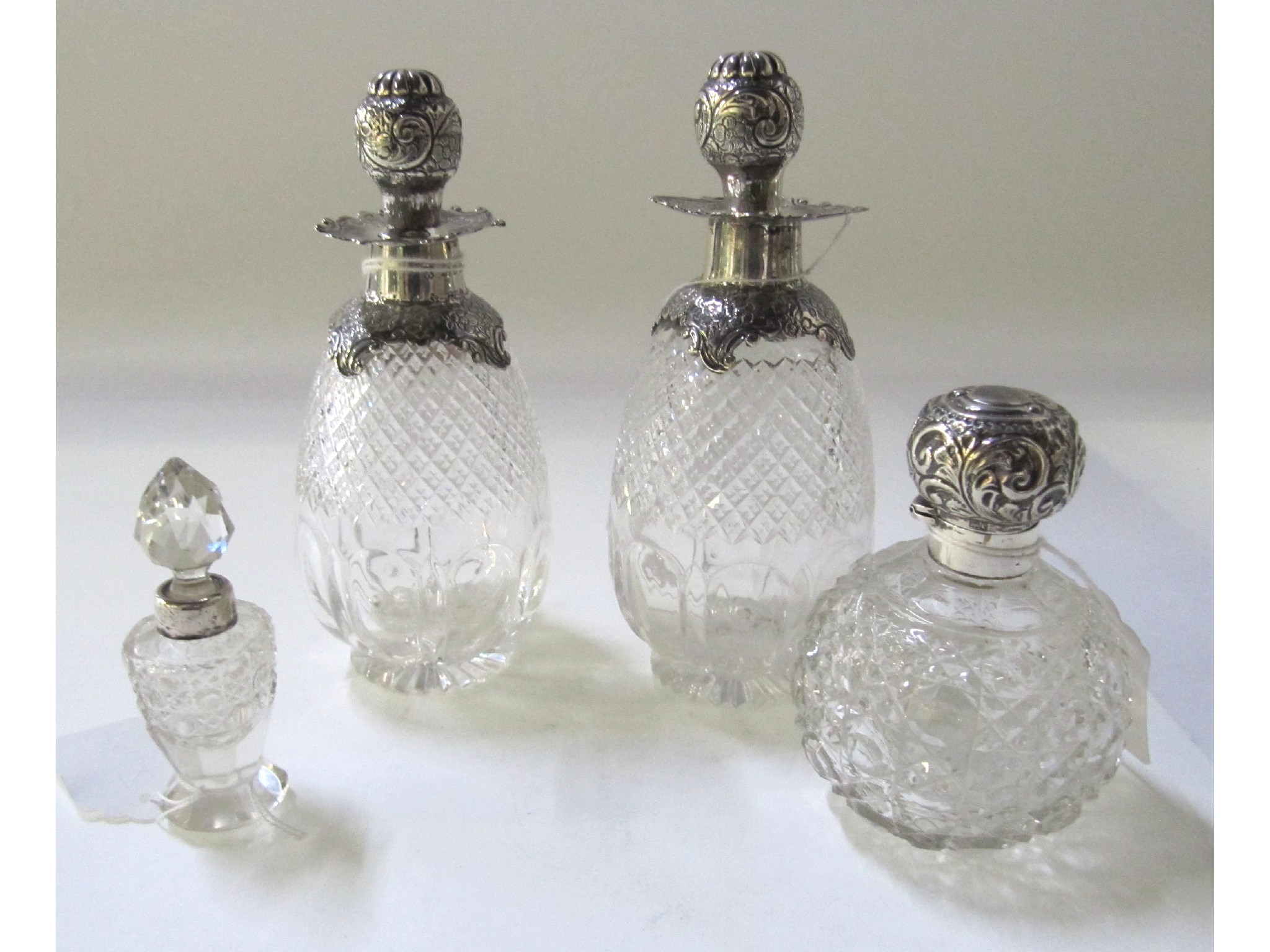 Appraisal: A lot comprising a pair of silver mounted scent bottles