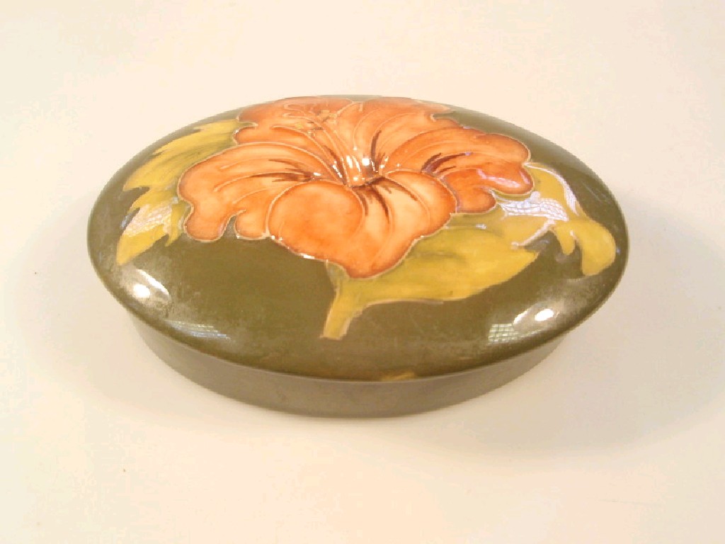 Appraisal: A Moorcroft oval dish and cover painted with an orange