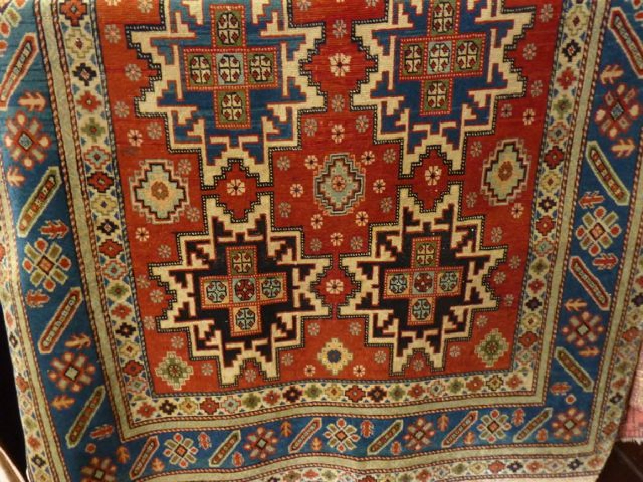 Appraisal: A Persian rug with multi-medallion centre of geometric form upon