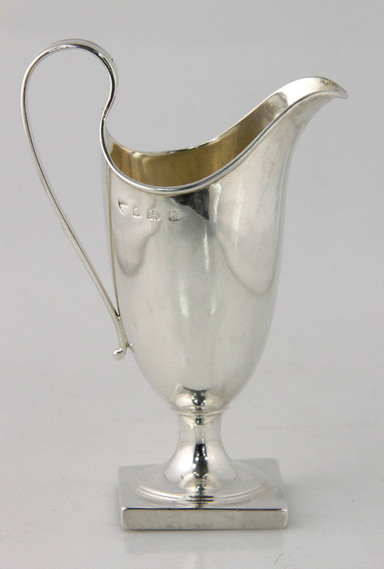 Appraisal: A silver cream jug Birmingham with loop handle on a