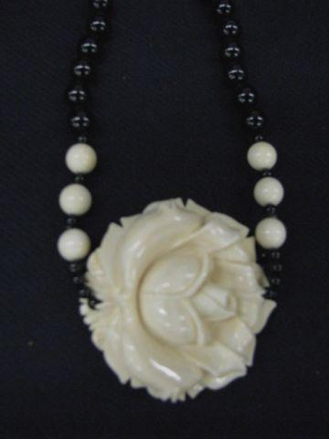 Appraisal: Carved Ivory Black Onyx Necklace beads with deeply carved rose