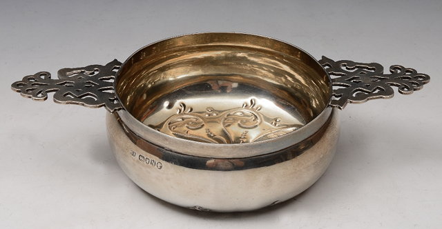 Appraisal: A VICTORIAN SILVER PORRINGER with pierced handle and chased lower