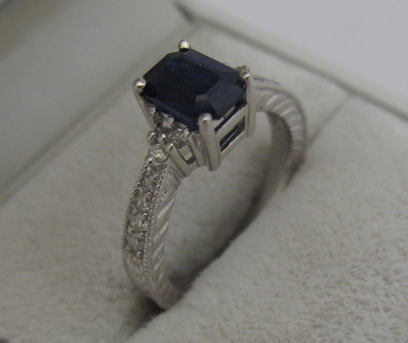 Appraisal: SAPPHIRE DIAMOND AND K WHITE GOLD RING centering an emerald-cut