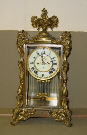 Appraisal: ANSONIA ORMOLU MOUNTED FOUR-GLASS CLOCK Urn form finial four sides