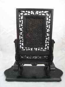 Appraisal: A very finely carved tortoiseshell panel in pierced ebony frame