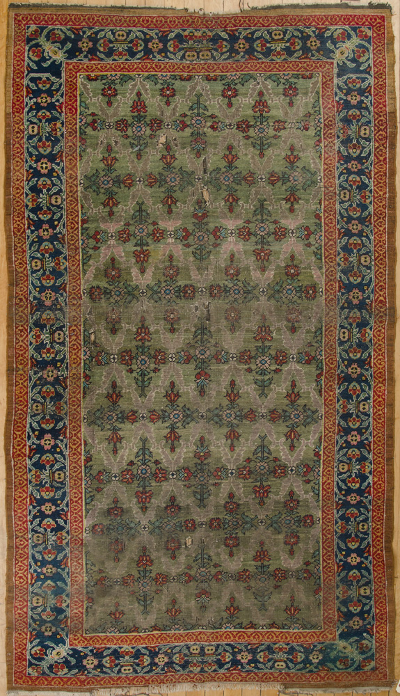 Appraisal: Persian Long Rug The green field worked with floral stems