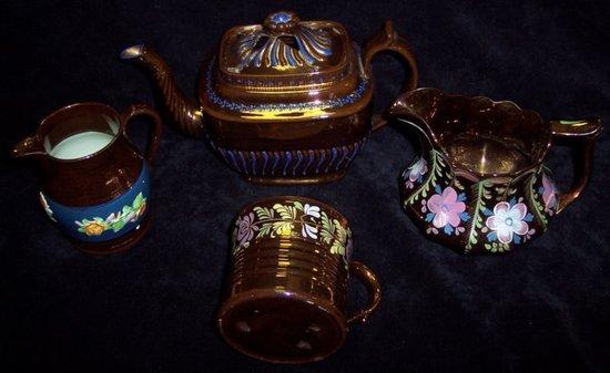 Appraisal: A copper lustre teapot and three further lustre items