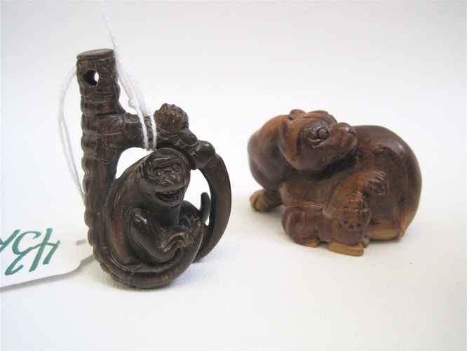 Appraisal: TWO JAPANESE CARVED WOOD NETSUKE a mother cat and her