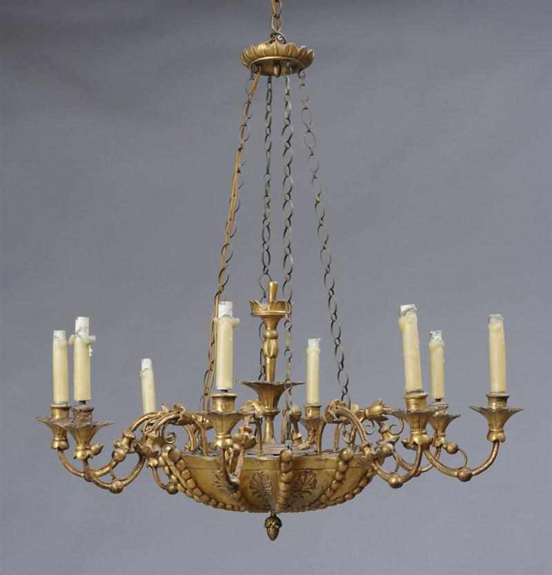 Appraisal: ITALIAN ROCOCO STYLE CARVED GILTWOOD EIGHT-LIGHT CHANDELIER The scalloped bead-carved