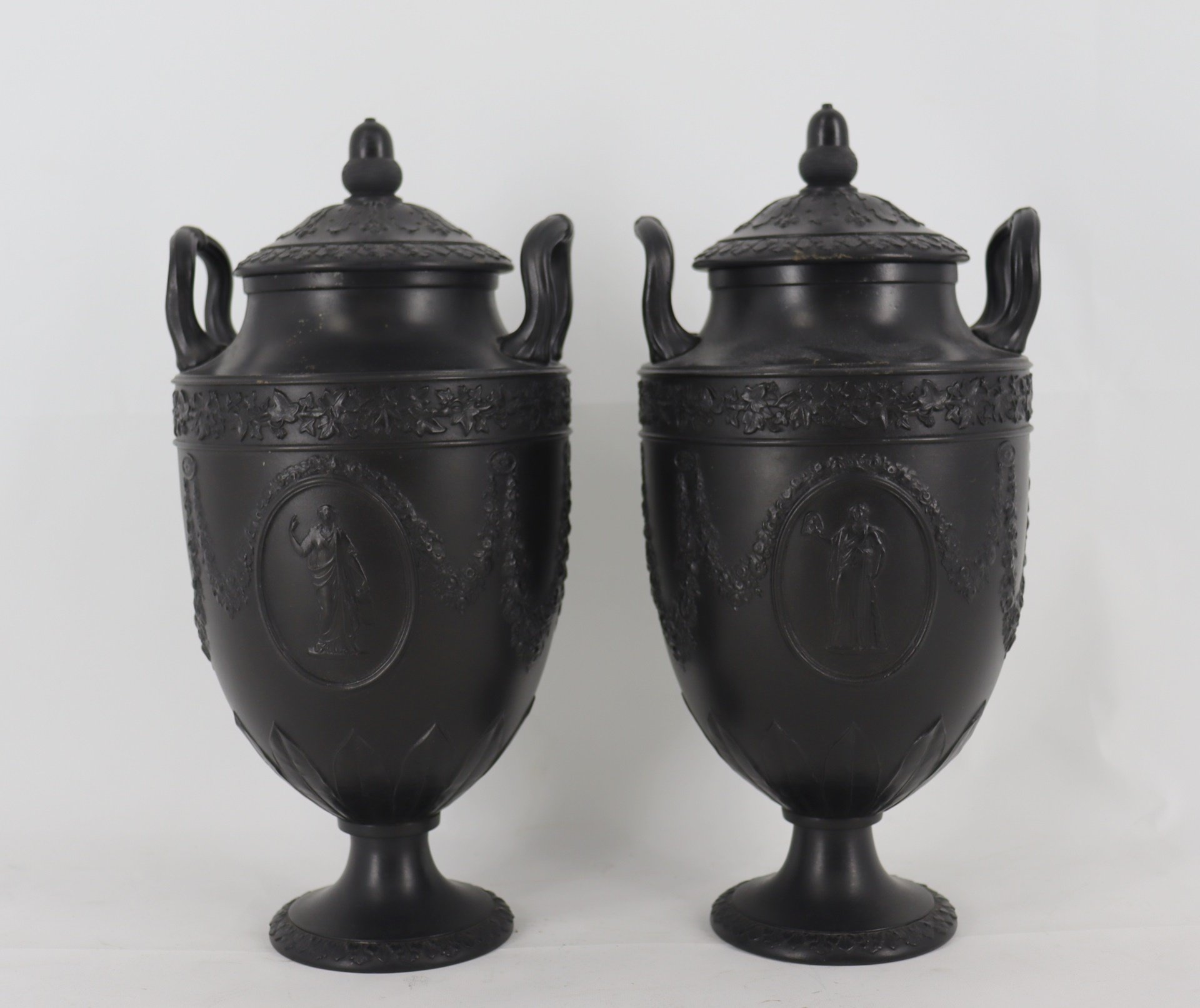 Appraisal: A Pair of Wedgwood Basalt Lidded Porcelain Urns From a