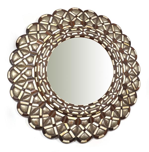 Appraisal: A MOROCCAN BONE AND METAL MOUNTED WALL MIRRORthe circular plate