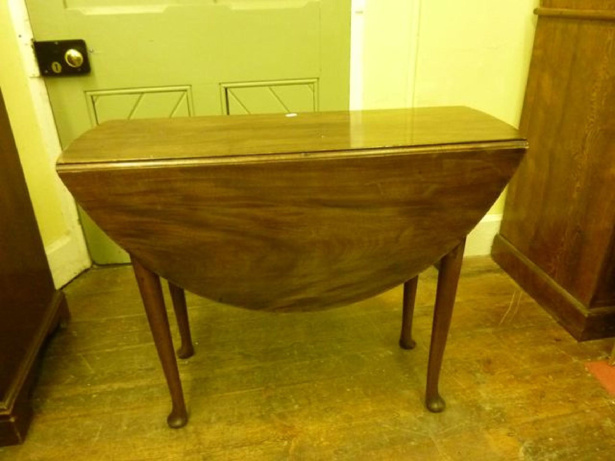 Appraisal: A Georgian mahogany pad foot table with oval drop leaves