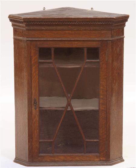 Appraisal: A th century oak corner cabinet the projected Greek key