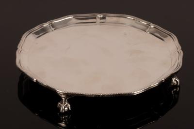 Appraisal: A silver salver retailed by Harrods London with pie crust