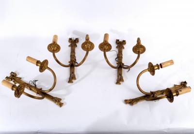 Appraisal: A set of four two-branch two-light wall lights each surmounted