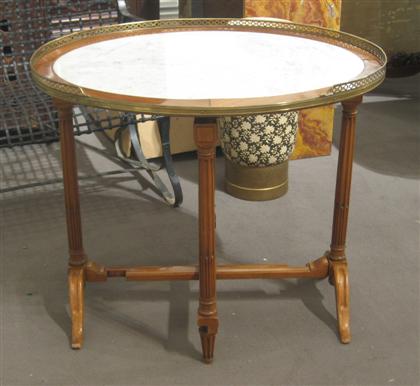 Appraisal: French fruitwood tilt top tea table The oval marble top