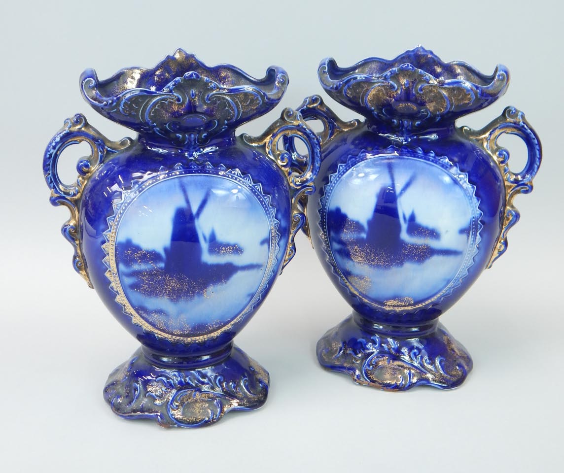 Appraisal: A pair of early thC Staffordshire pottery vases each decorated