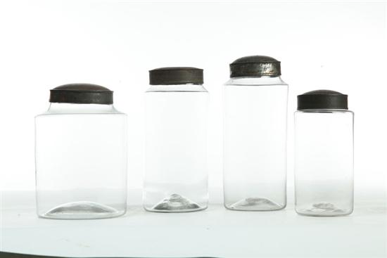 Appraisal: FOUR BLOWN GLASS STORAGE JARS WITH TIN LIDS American mid