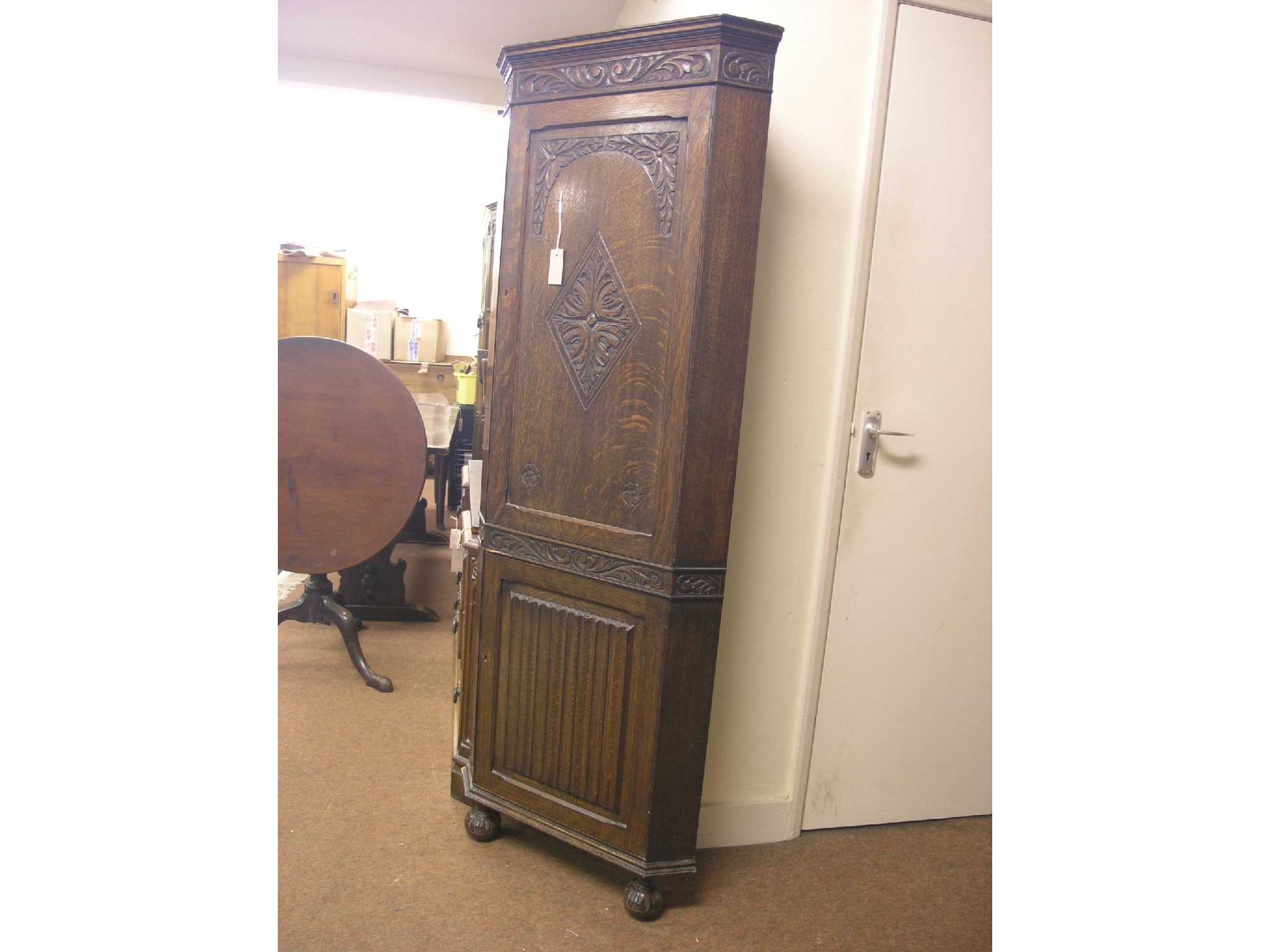 Appraisal: An early th century solid dark oak corner cupboard floor-standing