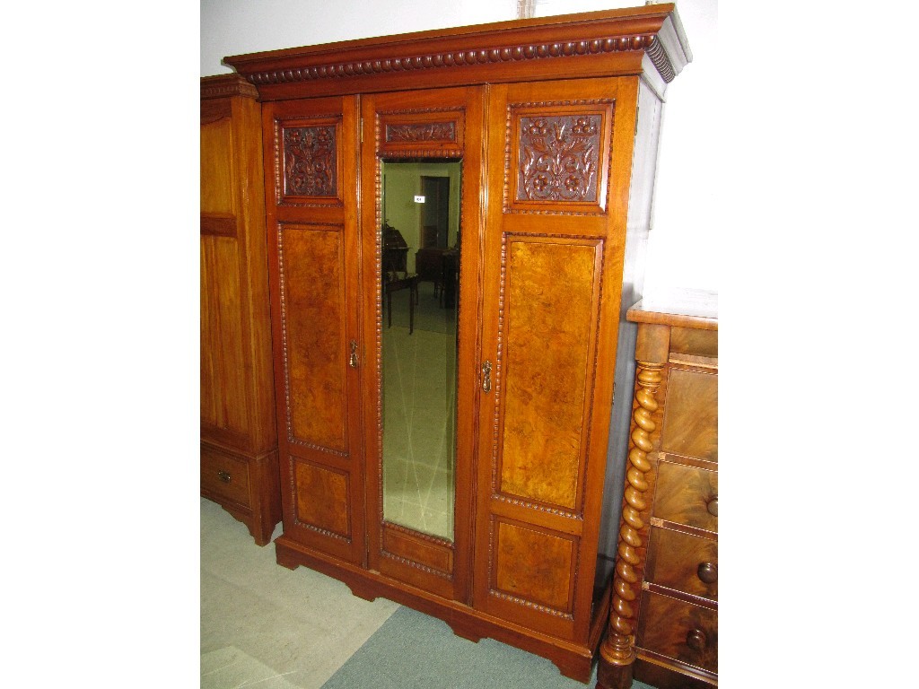 Appraisal: Victorian carved walnut three section mirror door wardrobe