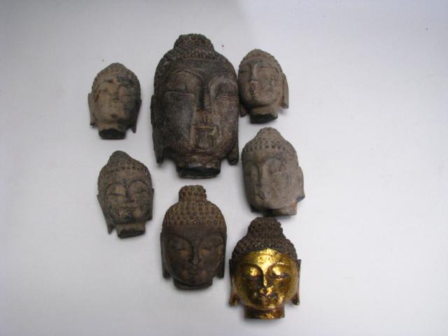 Appraisal: Group of seven Heads of Buddha ranging in size from