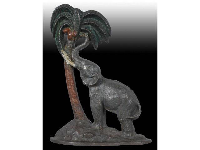 Appraisal: Elephant by Coconut Tree Cast Iron Doorstop Description Depicts elephant