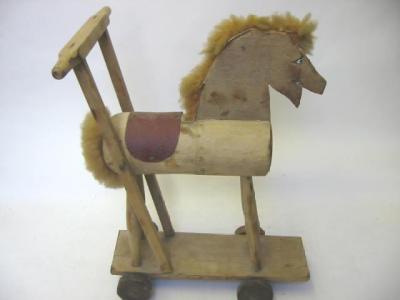 Appraisal: A push-along horse on wheels wood construction with nylon mane