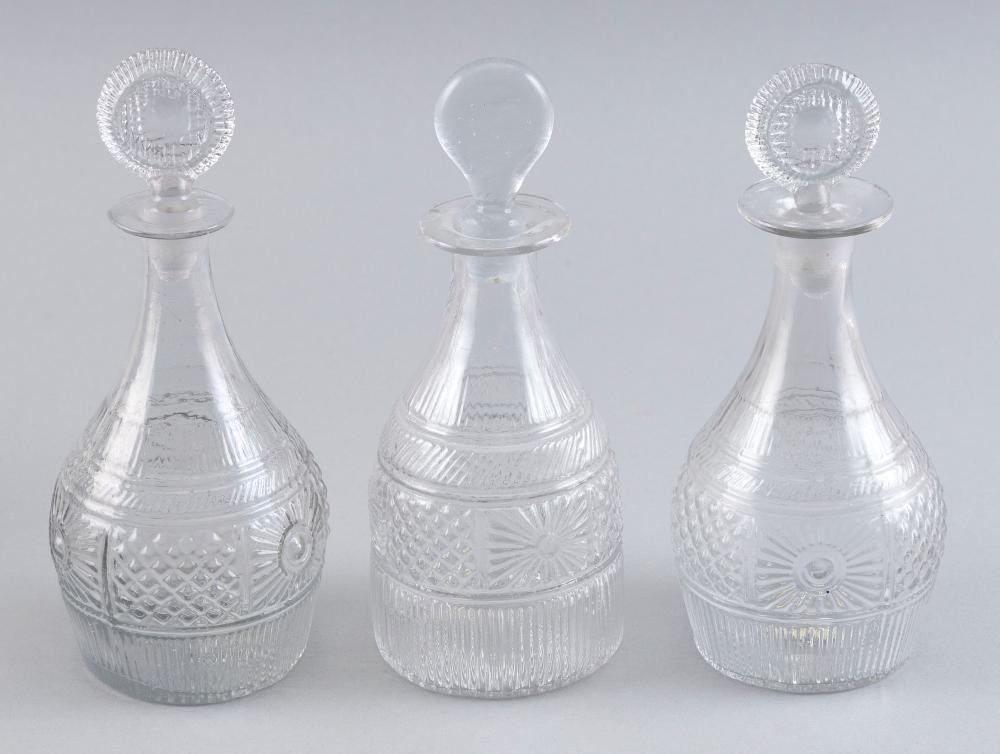 Appraisal: THREE BLOWN MOLDED CLEAR GLASS DECANTERS TH CENTURY HEIGHTS THREE