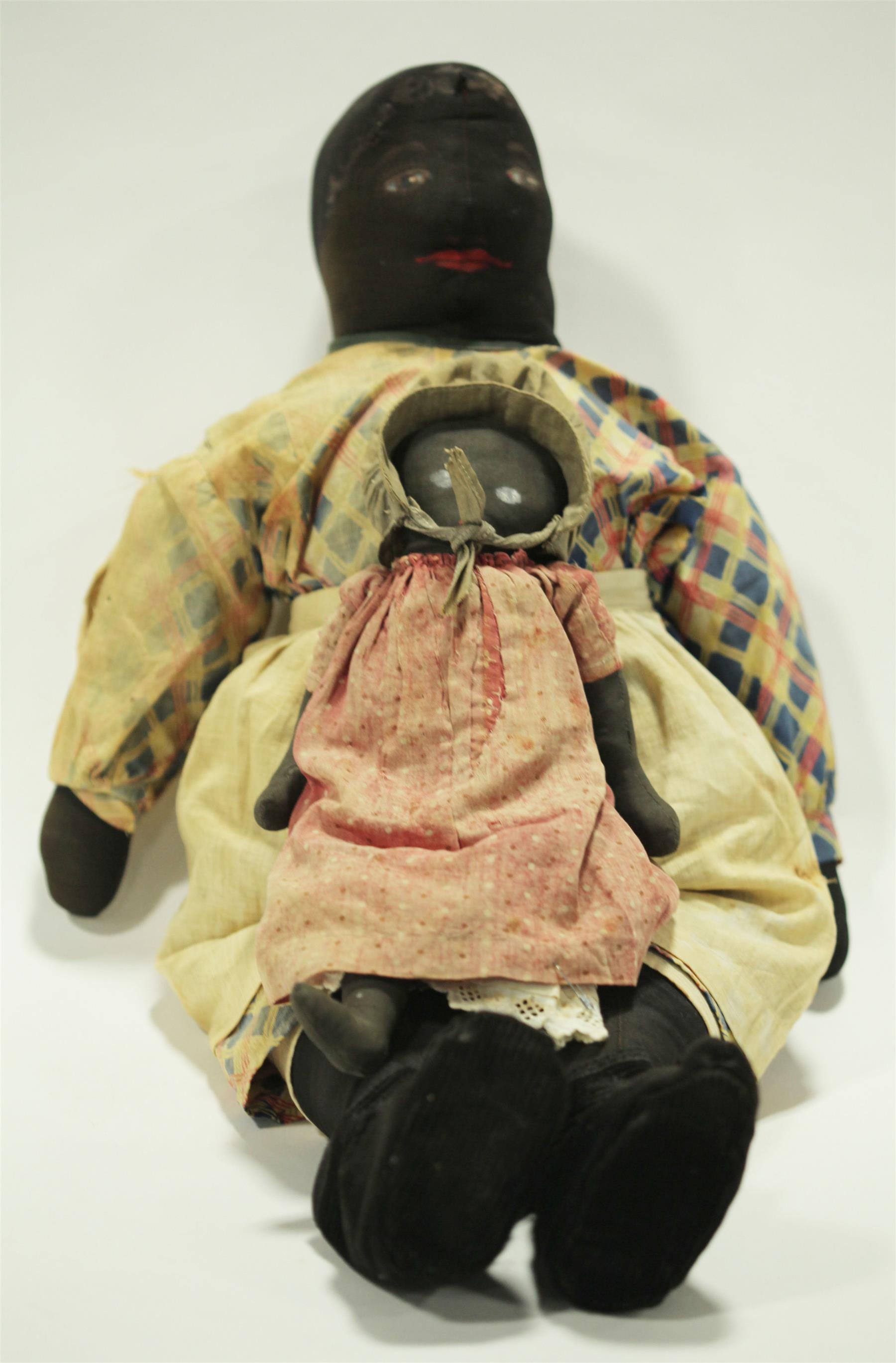 Appraisal: TWO EARLY BLACK CLOTH DOLLS WITH PAINTED FACES Late th-early