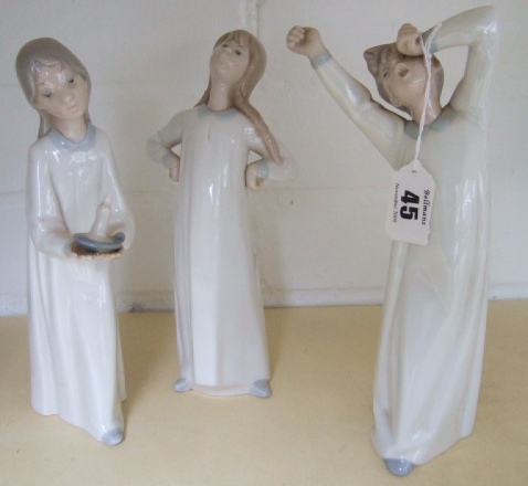 Appraisal: A group of three Lladro children in night dress