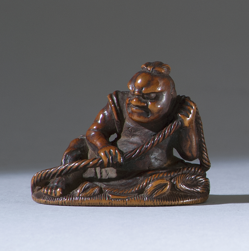 Appraisal: WOOD NETSUKE th CenturyBy Shoju Depicting a nio tying a