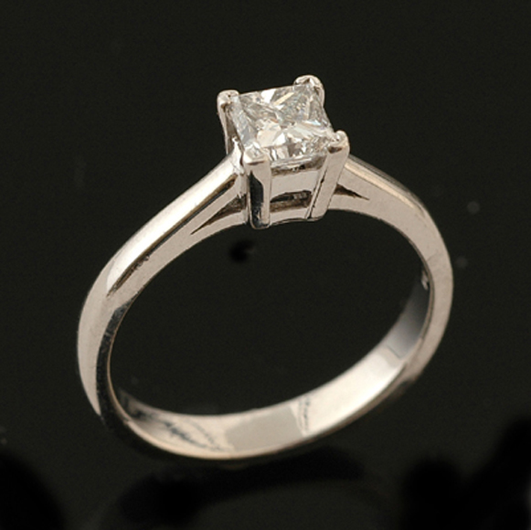 Appraisal: A diamond solitaire ring The princess cut diamond weighing cts