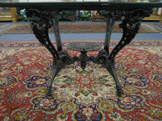 Appraisal: Cast Iron Table very ornate center shelf oval glass top