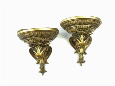 Appraisal: A pair of gilt composition brackets with mask and scroll