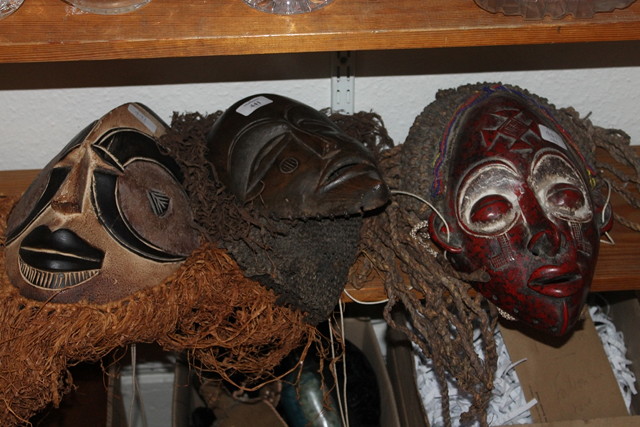 Appraisal: A COLLECTION OF THREE TRIBAL MASKS of stylised form one