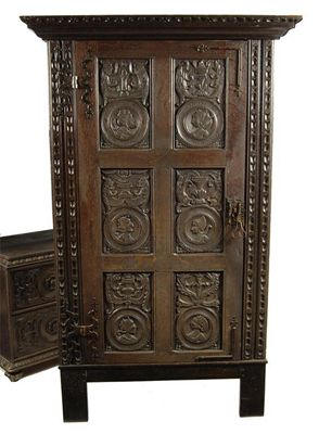 Appraisal: A carved oak cupboard on a later stand the hinged