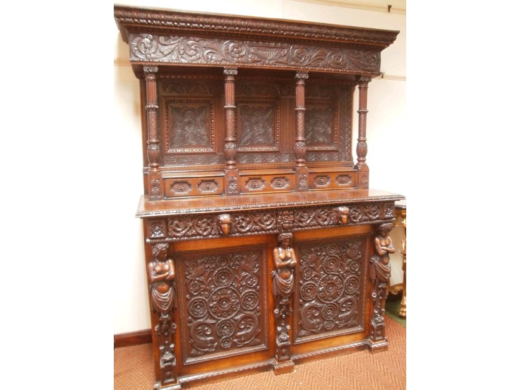 Appraisal: A thC elaborately carved oak buffet sideboard the stepped canopy